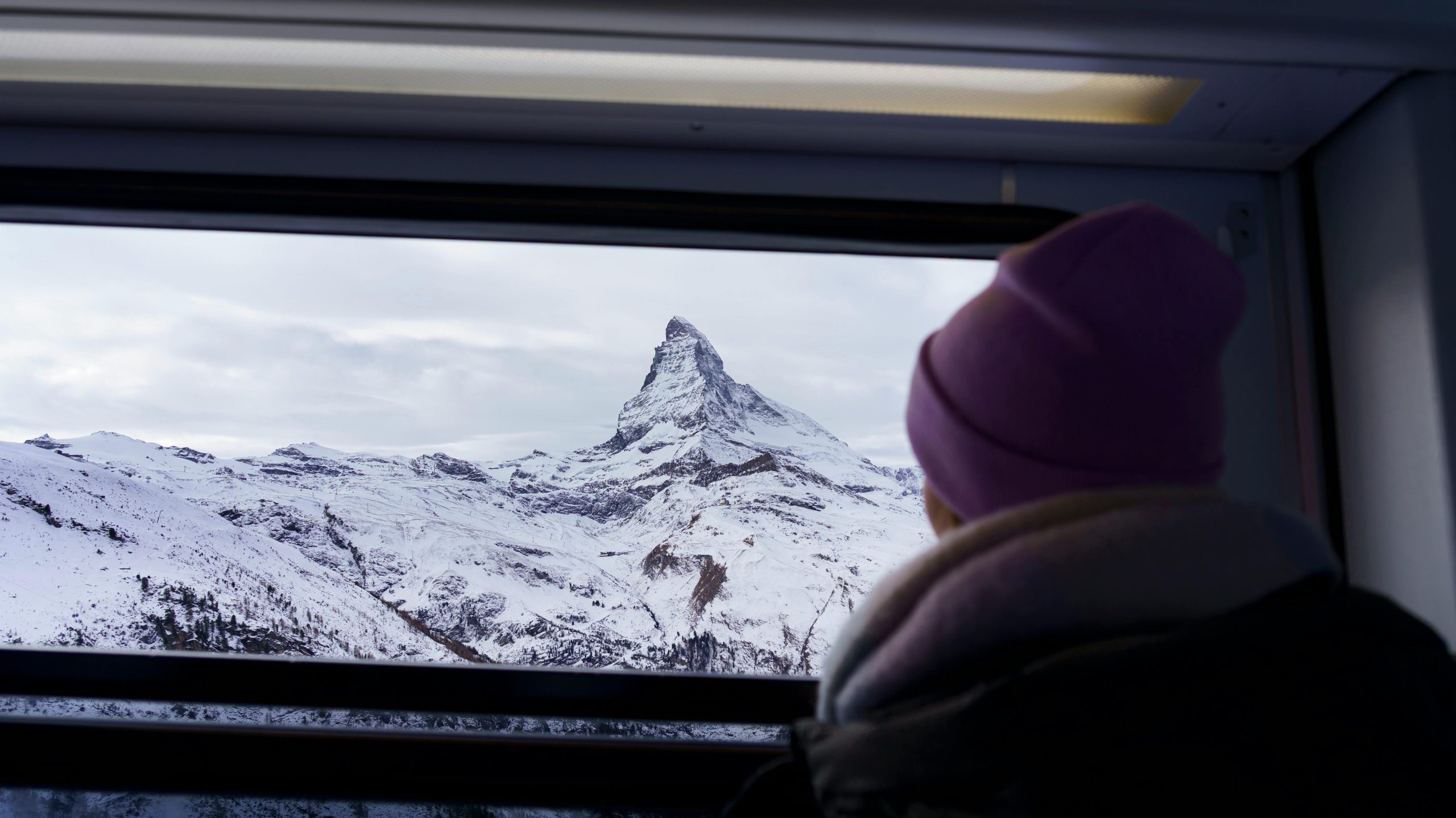 Beautiful snowy mountain view from the window of train in Switzerland